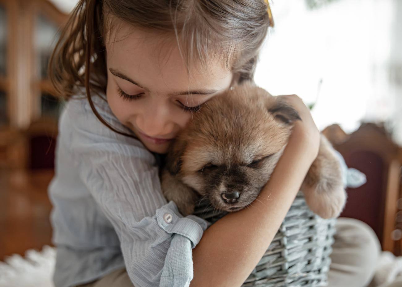 Una bambina e il suo cane seduti all’aria aperta