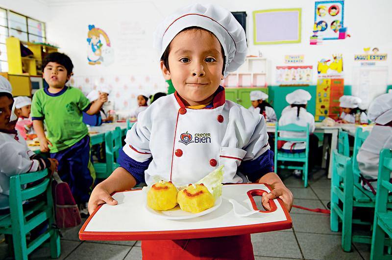 Bambino a scuola con un vassoio di cibo